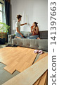 Young couple measuring wall while planning furniture placement 141397663