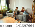 Young couple comparing home improvement products across digital devices 141397664