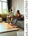 Young couple planning renovation with laptop and smartphone 141397669
