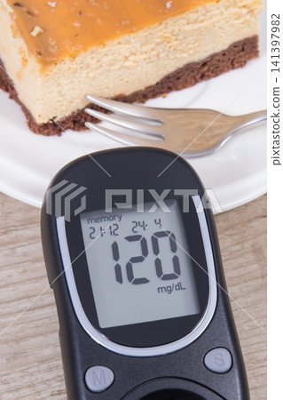Glucometer and portion of cheesecake. Measuring and checking sugar level during diabetes Glucometer and portion of cheesecake. Measuring and checking sugar level during diabetes 141397982