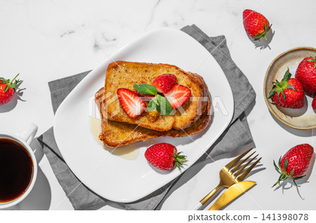 Brioche toasts with strawberry and honey on a plate on a marble background Brioche toasts with strawberry and honey on a plate on a marble background 141398078