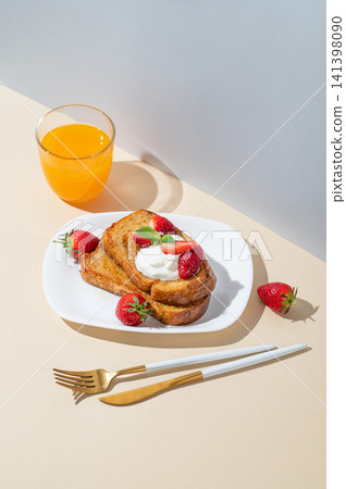 Brioche toasts with strawberries and whipped cream, drizzled with honey on a plate Brioche toasts with strawberries and whipped cream, drizzled with honey on a plate 141398090