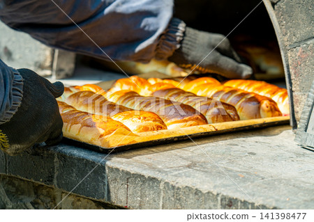 The pies are baked in the oven. 141398477