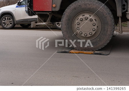 Large truck wheel on portable weighing scales for axle load control Large truck wheel on portable weighing scales for axle load control 141399265