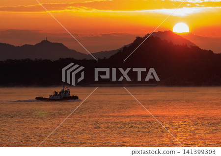 Sunrise over the Seto Inland Sea, Hiroshima Prefecture, with sea fog drifting across it. Sunrise over the Seto Inland Sea, Hiroshima Prefecture, with sea fog drifting across it. 141399303