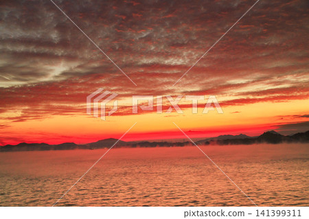 Morning glow over the Seto Inland Sea, Hiroshima Prefecture, with sea fog drifting through the water. Morning glow over the Seto Inland Sea, Hiroshima Prefecture, with sea fog drifting through the water. 141399311