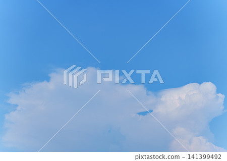 White cumulonimbus clouds spread across the summer blue sky, with space for text. White cumulonimbus clouds spread across the summer blue sky, with space for text. 141399492