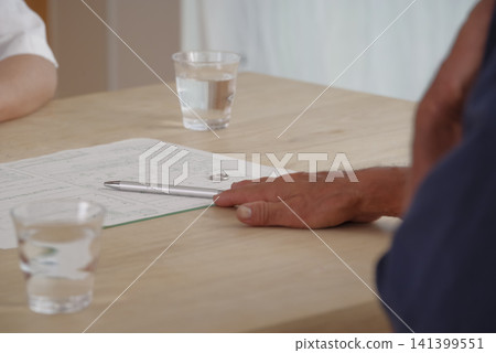 A senior couple discusses their divorce while looking at divorce papers. A senior couple discusses their divorce while looking at divorce papers. 141399551