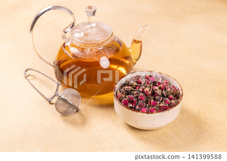 Rosebud herbal tea infusing in glass teapot Rosebud herbal tea infusing in glass teapot 141399588