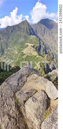 Top-down view of the Machu Picchu archaeological complex surrounded by mountains, Peru 141399602