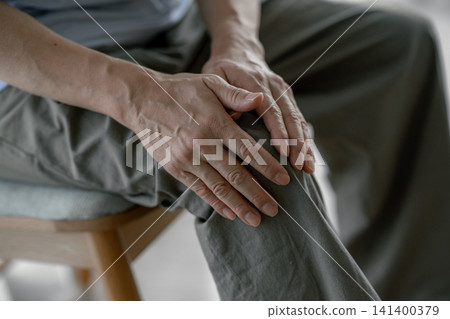 A senior man suffering from knee pain A senior man suffering from knee pain 141400379