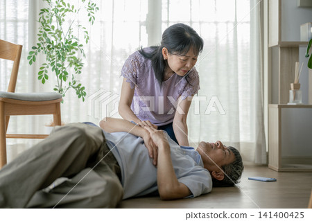 Wife checks on her husband after he collapses. Wife checks on her husband after he collapses. 141400425