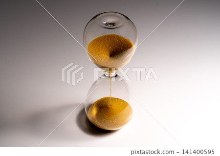 A still-life image depicting time using a glass hourglass. A still-life image depicting time using a glass hourglass. 141400595
