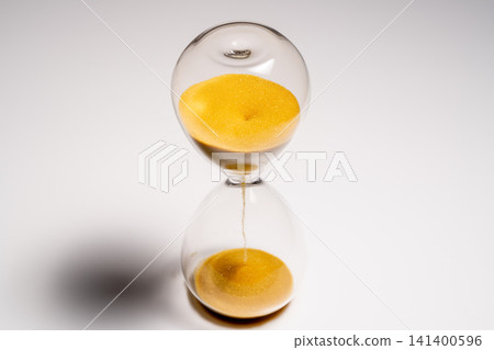 The hourglass with flowing yellow sand represents time management. The hourglass with flowing yellow sand represents time management. 141400596