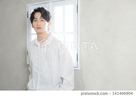 Young man at the window side Young man at the window side 141400904