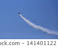 The Blue Impulse aerobatic team flies, drawing white smoke trails across the blue sky. 141401122