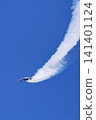 The Blue Impulse aerobatic team flies, drawing white smoke trails across the blue sky. 141401124