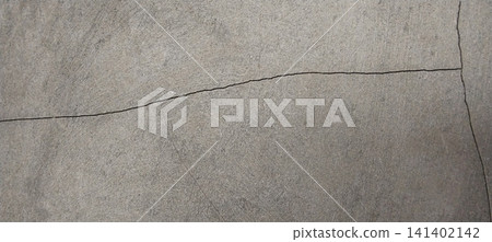 Horizontal and vertical cracks on a smooth gray concrete surface. Horizontal and vertical cracks on a smooth gray concrete surface. 141402142