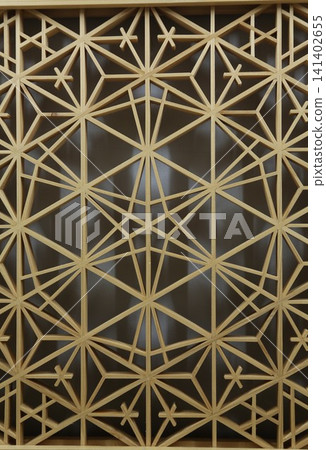 Traditional Japanese woodworking technique: Kumiko latticework, geometric patterns in wooden decoration, traditional Japanese craft, background material. Traditional Japanese woodworking technique: Kumiko latticework, geometric patterns in wooden decoration, traditional Japanese craft, background material. 141402655