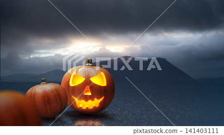 A carved, glowing Halloween pumpkin next to an uncarved one against a moody mountain landscape under dark, stormy skies. Concept of Halloween. Horror or Halloween background A carved, glowing Halloween pumpkin next to an uncarved one against a moody mountain landscape under dark, stormy skies. Concept of Halloween. Horror or Halloween background 141403111