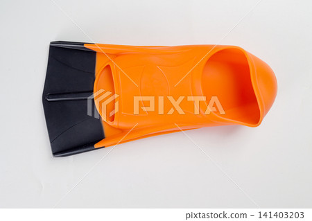 A single orange and black rubber swim fin or flipper, used for swimming, snorkeling, or diving training, shot from above on a clean white background 141403203