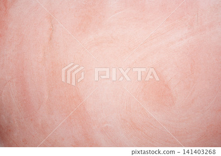 A soft pink and coral textured plaster background with a subtle, fine-grained stucco finish A soft pink and coral textured plaster background with a subtle, fine-grained stucco finish 141403268