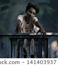 A terrifying zombie man with bloody makeup and torn clothes leaning over an old balcony railing, reaching his hands out in a dark horror scene for Horror or Halloween. Concept of Halloween 141403937