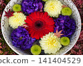 Flowers arranged in a pot placed in the garden of a temple in Kyoto 141404529