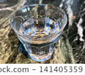 Glasses of water on a marble-patterned table 141405359