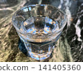Glasses of water on a marble-patterned table 141405360