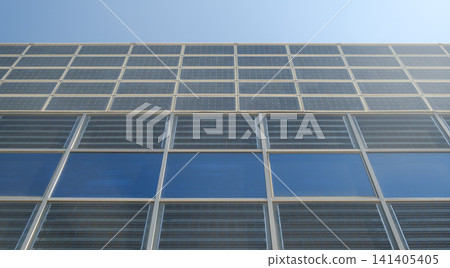 Modern building facade featuring solar panels and glass, showcasing sustainable architecture and solar energy efficiency. Modern building facade featuring solar panels and glass, showcasing sustainable architecture and solar energy efficiency. 141405405