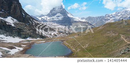 Iconic Reflection of Matterhorn Mountain in Riffelsee Lake, Zermatt, Switzerland, Snow Capped Swiss Alps under Blue Sky, Famous Landmark landscape and popular European Travel Destination Iconic Reflection of Matterhorn Mountain in Riffelsee Lake, Zermatt, Switzerland, Snow Capped Swiss Alps under Blue Sky, Famous Landmark landscape and popular European Travel Destination 141405444