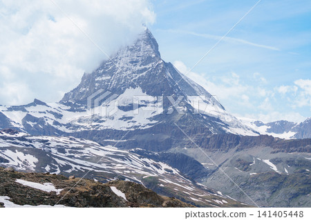 Scenic Hiking Trail with Iconic Matterhorn Mountain in Zermatt, Switzerland, Beautiful Swiss Alps Landscape under Blue Sky and White Clouds, Famous Landmark and popular European Travel Destination Scenic Hiking Trail with Iconic Matterhorn Mountain in Zermatt, Switzerland, Beautiful Swiss Alps Landscape under Blue Sky and White Clouds, Famous Landmark and popular European Travel Destination 141405448