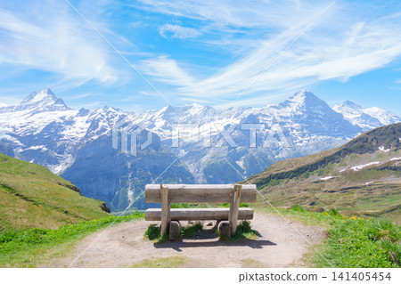 Scenic view of Swiss Alps with bench for taking view at Grindelwald First, Switzerland. Beautiful landscape in Jungfrau Region. famous Europe summer hiking trail and travel destination Scenic view of Swiss Alps with bench for taking view at Grindelwald First, Switzerland. Beautiful landscape in Jungfrau Region. famous Europe summer hiking trail and travel destination 141405454