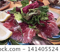 Fresh fish carpaccio with green salad 141405524
