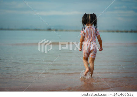preschool child girl walking on sea beach in Pattaya, Thailand preschool child girl walking on sea beach in Pattaya, Thailand 141405532