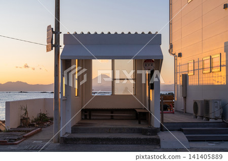 A sunset view of the coast with the Manase bus stop in Hayama town and Mount Fuji in the background. A sunset view of the coast with the Manase bus stop in Hayama town and Mount Fuji in the background. 141405889