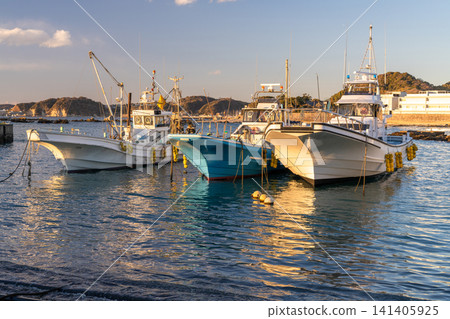 Fishing boats moored at Manase Fishing Port in Hayama Town, and the harbor scenery at dusk. Fishing boats moored at Manase Fishing Port in Hayama Town, and the harbor scenery at dusk. 141405925