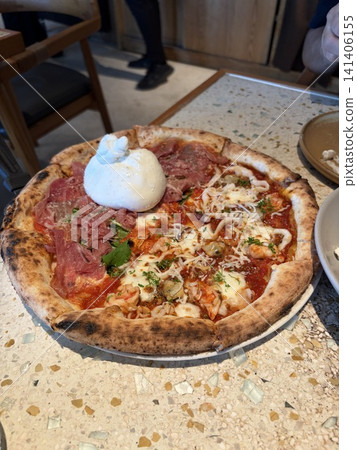 A half-and-half pizza with too much burrata cheese. A half-and-half pizza with too much burrata cheese. 141406155