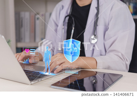 Doctor using laptop with virtual medical shield icon and human anatomy hologram. Concept of health insurance coverage, medical data protection, and digital healthcare security. Doctor using laptop with virtual medical shield icon and human anatomy hologram. Concept of health insurance coverage, medical data protection, and digital healthcare security. 141406671