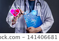 Doctor using digital interface with heart rate monitor and medical charts. Cardiologist analyzing ECG data on a futuristic holographic screen for diagnosis and smart healthcare concept. 141406681