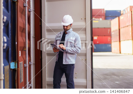 Logistics worker checking shipping container with digital tablet Logistics worker checking shipping container with digital tablet 141406847