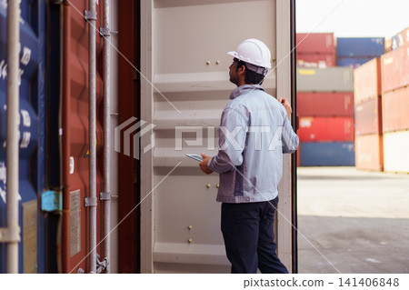 Logistics worker checking shipping container with digital tablet 141406848