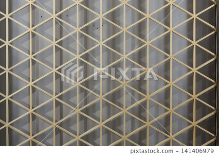 Traditional Japanese woodworking technique: Kumiko latticework, geometric patterns in wooden decoration, traditional Japanese craft, background material. Traditional Japanese woodworking technique: Kumiko latticework, geometric patterns in wooden decoration, traditional Japanese craft, background material. 141406979