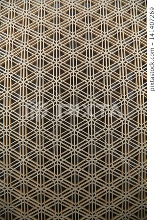 Traditional Japanese woodworking technique: Kumiko latticework, geometric patterns in wooden decoration, traditional Japanese craft, background material. Traditional Japanese woodworking technique: Kumiko latticework, geometric patterns in wooden decoration, traditional Japanese craft, background material. 141407269