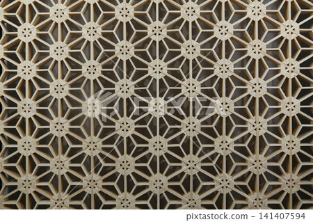 Traditional Japanese woodworking technique: Kumiko latticework, geometric patterns in wooden decoration, traditional Japanese craft, background material. Traditional Japanese woodworking technique: Kumiko latticework, geometric patterns in wooden decoration, traditional Japanese craft, background material. 141407594