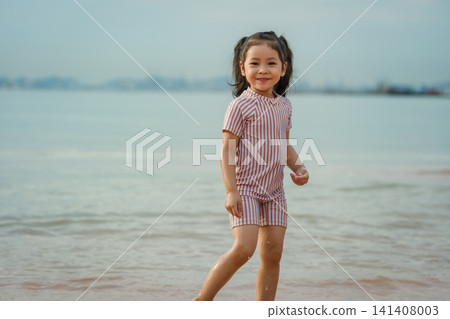 happy preschool child girl playing on sea beach in Pattaya, Thailand happy preschool child girl playing on sea beach in Pattaya, Thailand 141408003