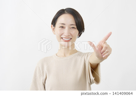 Woman making a check sign, middle-aged, white background 141409064