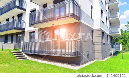 European residential architecture harmonizing with nature. Eco-friendly living in city with greens. Eco apartment building saving energy and fresh air concept.  141409121