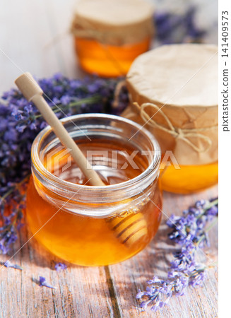 Lavender honey jars on rustic wooden background Lavender honey jars on rustic wooden background 141409573
